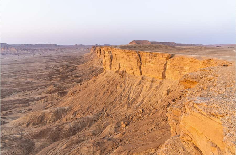 From Riyadh: Tuwaiq Mountains and Najd Plateau Day Trip - Tuwaiq rock, open sky, and a desert walk